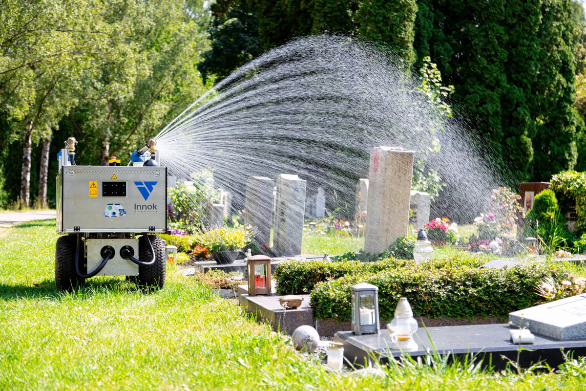 RAINOS watering robot irrigating graves in a cemetery